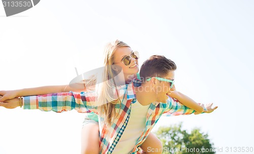 Image of smiling couple having fun in park