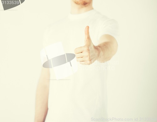 Image of man showing thumbs up