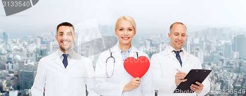 Image of group of smiling doctors with red heart shape