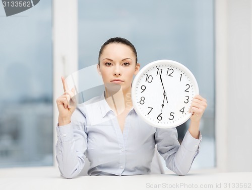 Image of attractive businesswoman with white clock