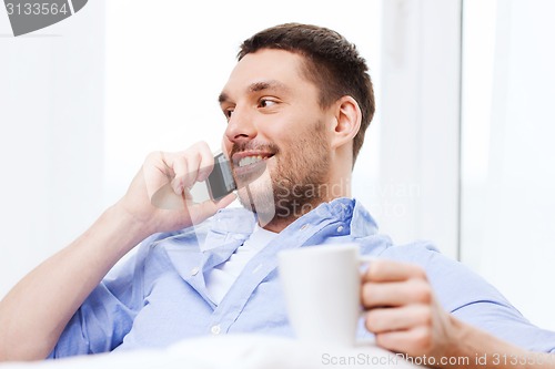 Image of close up of smiling businessman with smartphone