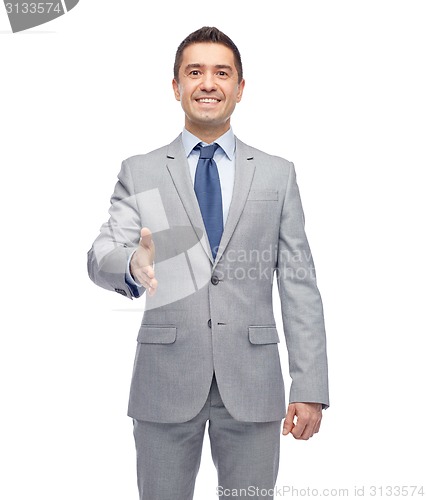 Image of happy smiling businessman in suit shaking hand