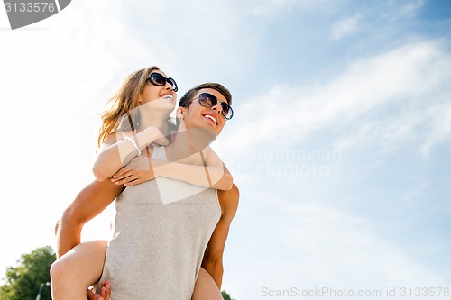 Image of smiling couple having fun over sky background