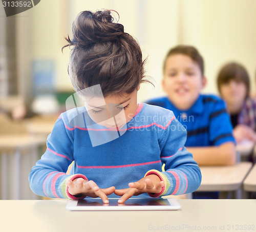 Image of little school girl with tablet pc over classroom