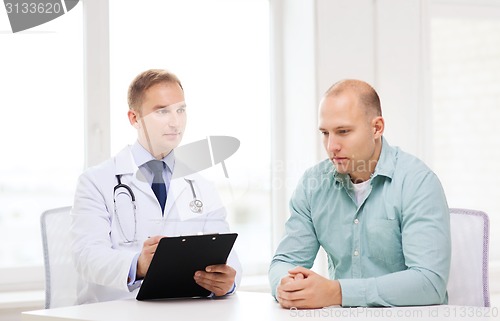 Image of doctor with clipboard and patient in hospital