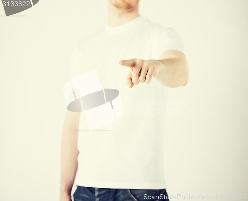 Image of man pointing his finger at you