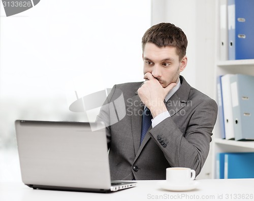 Image of busy businessman with laptop and coffee