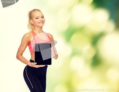 Image of smiling woman showing tablet pc blank screen