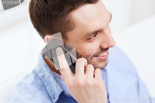 Image of close up of smiling businessman with smartphone
