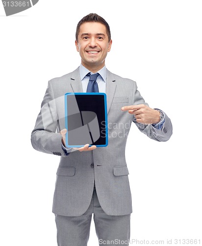 Image of happy businessman in suit showing tablet pc screen