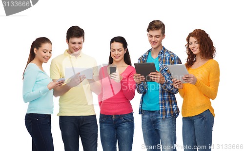 Image of group of teenagers with smartphones and tablet pc