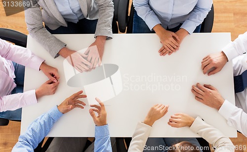 Image of close up of business team sitting at table