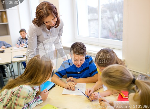 Image of group of school kids writing test in classroom