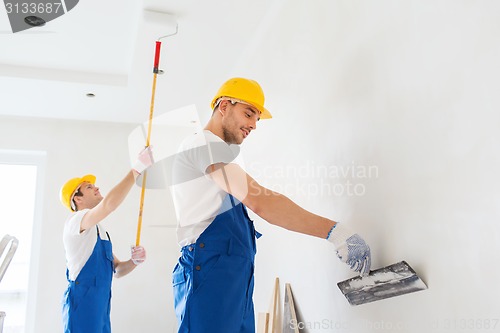 Image of group of builders with tools indoors