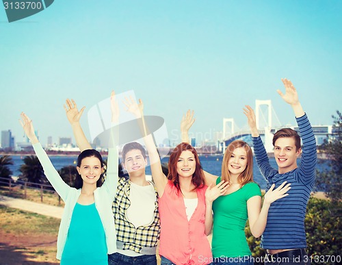 Image of group of smiling students waving hands