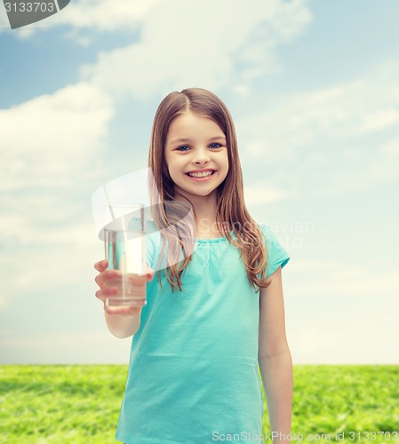 Image of smiling little girl giving glass of water