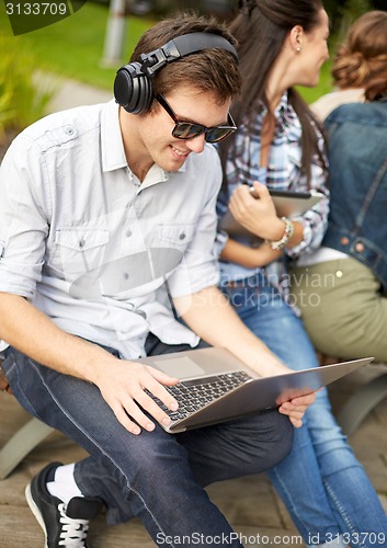 Image of students or teenagers with laptop computers