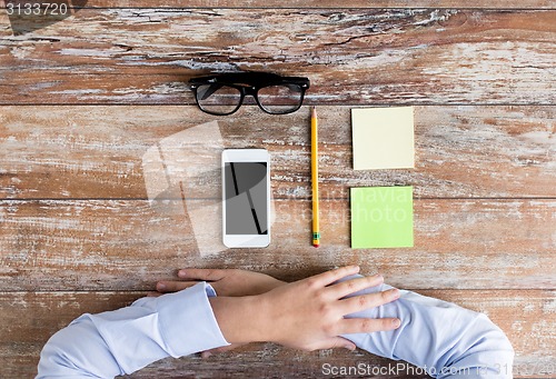 Image of close up of hands with office stuff on table