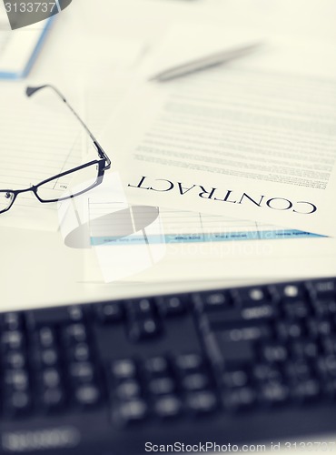 Image of signed contract paper with glasses