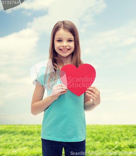 Image of smiling little girl with red heart
