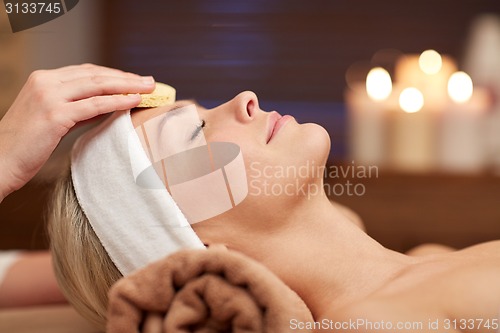 Image of close up of woman having face cleaning in spa