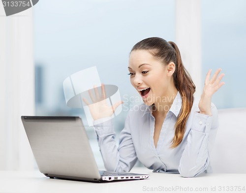 Image of surprised businesswoman with laptop