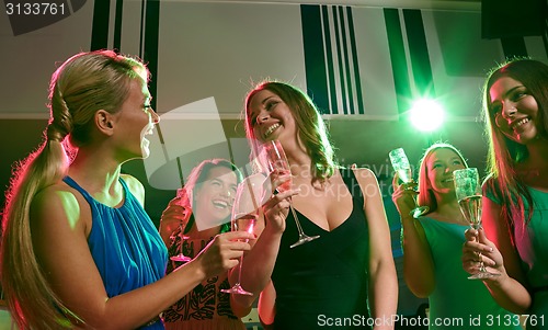Image of young women with glasses of champagne in club