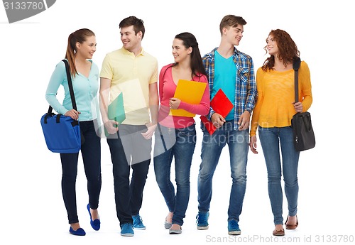 Image of group of smiling teenagers with folders and bags