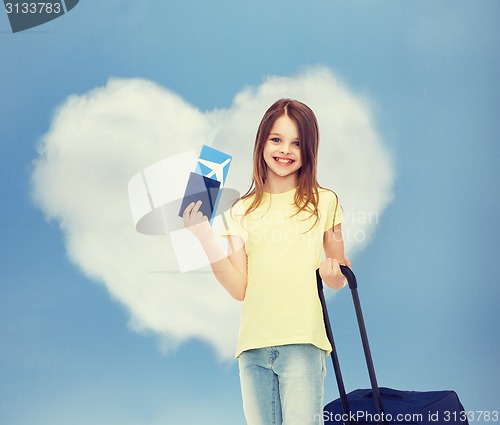 Image of smiling girl with travel bag ticket and passport