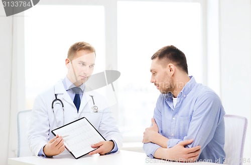 Image of doctor with clipboard and patient in hospital