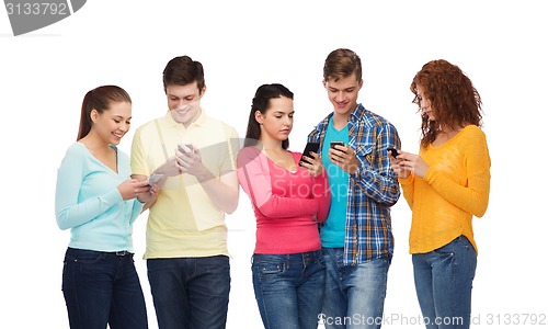 Image of group of smiling teenagers with smartphones