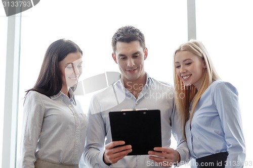 Image of business team looking at clipboard