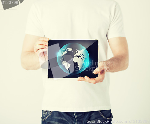 Image of man hands holding tablet pc with sign of globe