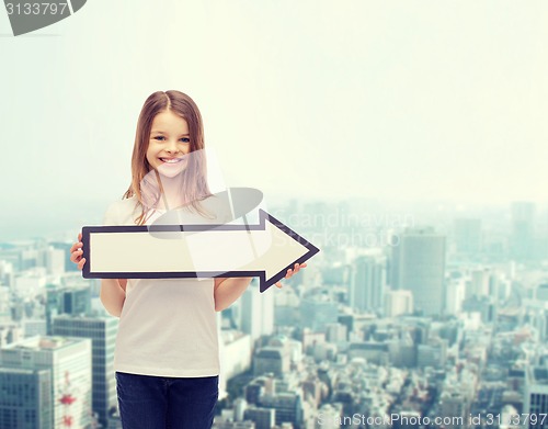 Image of smiling girl with blank arrow pointing right