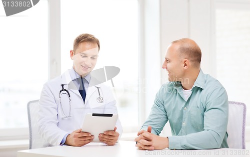 Image of doctor with tablet pc and patient in hospital