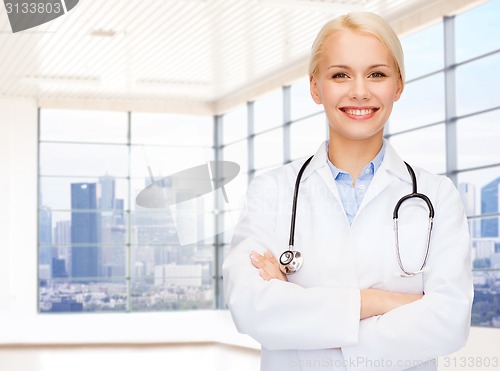 Image of smiling young female doctor in white coat