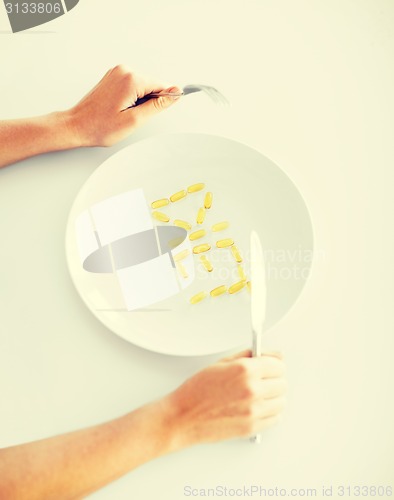 Image of woman with plate and meds