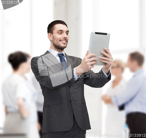 Image of smiling buisnessman with tablet pc computer