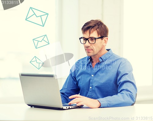 Image of man working with laptop at home