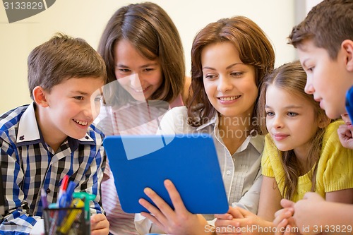 Image of group of kids with teacher and tablet pc at school