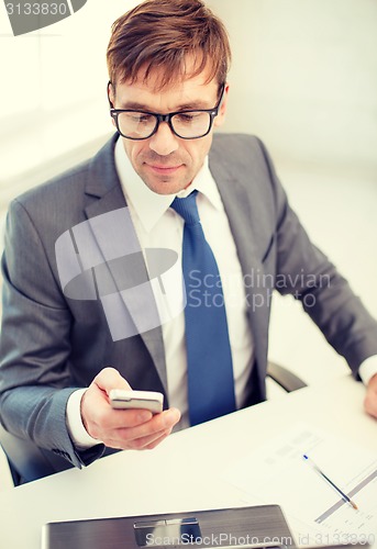 Image of businessman working with laptop and smartphone