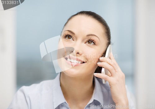 Image of african businesswoman with smartphone in office