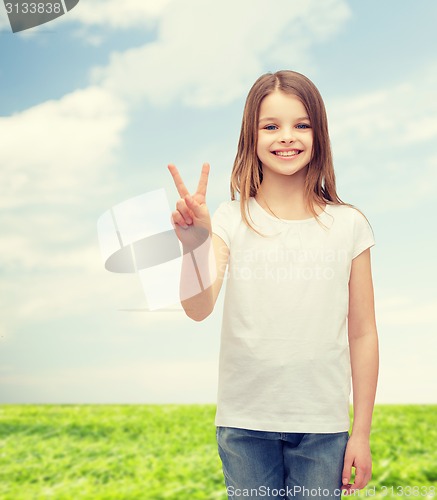 Image of little girl in white t-shirt showing peace gesture