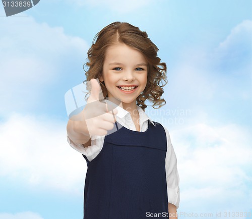 Image of happy little school girl showing thumbs up