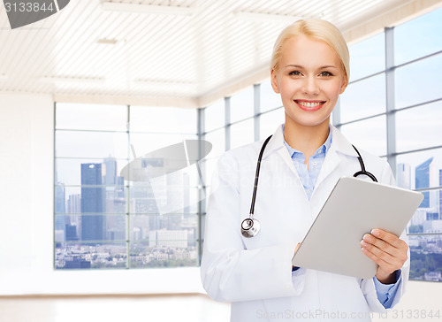 Image of smiling young female doctor in white coat