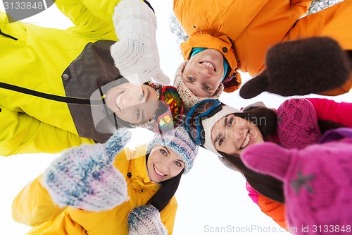 Image of happy friends in winter clothes outdoors
