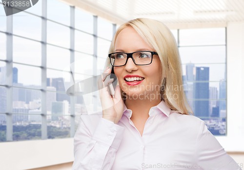 Image of smiling businesswoman calling on smartphone