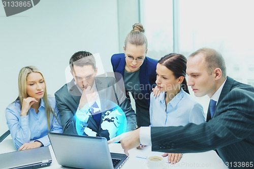 Image of business team with laptop having discussion