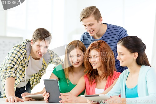 Image of smiling students with tablet pc at school
