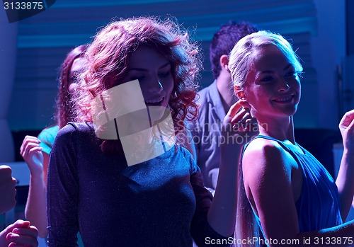 Image of group of happy friends dancing in night club